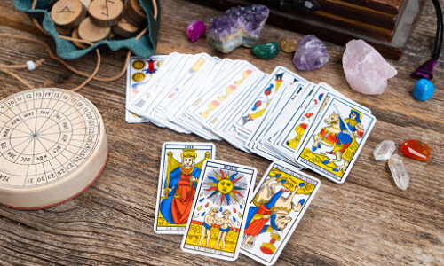 Fortune telling on tarot cards, used Marseille Tarot deck by unknown artist published first in 1709